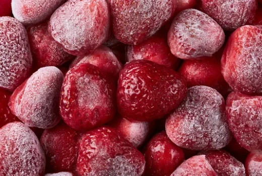 Overhead view of IQF frozen strawberries, frosted and individually separated